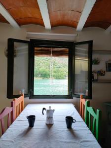 a dining room table with a tea pot on it at Lo Raconet in Sant Llorenç de Montgai