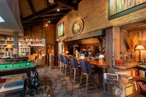 a library with a pool table and a bar at Wellnesshotel Seeschlößchen - Privat- Spa & Naturresort in Senftenberg