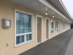 a row of windows on the side of a building at Auberge Du Lac Beauchamp in Gatineau