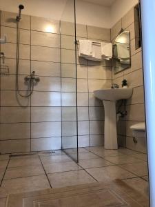 a bathroom with a shower and a sink at Rajana Bungalow - Ulcinj in Ulcinj