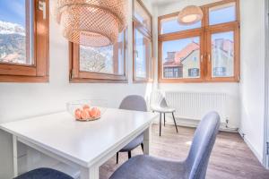 a dining room with a white table and chairs at InnsbruckHomes at Botanical Garden in Innsbruck