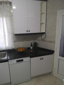 モロ・デル・ハブレにあるCasa Morisca Lapiadaのキッチン(白いキャビネット付)、カウンターにフルーツを用意しています。