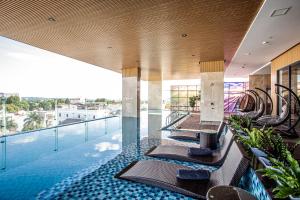 a hotel pool with chairs and a swimming pool at Thanh Mai Hotel in Buon Ma Thuot