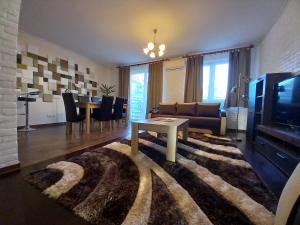 a living room with a couch and a table at Thermal apartman in Hajdúszoboszló