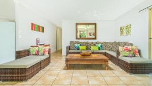 a living room with two couches and a coffee table at Island Time Villas in Titikaweka