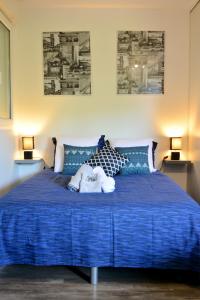 a blue bed with a stuffed animal on top of it at STUDIO'MARCEL in Blagnac