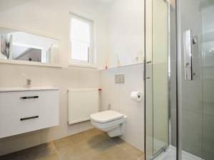 a bathroom with a toilet and a glass shower at Willa u Tośka in Kołobrzeg +20 photos