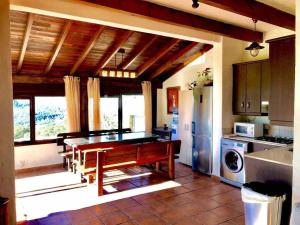 a kitchen with a dining room table and a refrigerator at Villa Paraiso. Villas Ahumada in Tarifa
