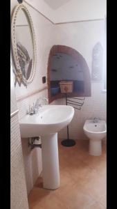a bathroom with a sink and a toilet at A casa dell’amica mia in San Nicola Arcella +35 photos