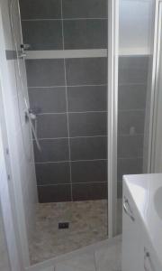 a shower with a glass door in a bathroom at gite notre désir 100 m de la mer in Jullouville-les-Pins