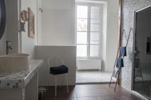 a bathroom with a sink and a counter with a mirror at Joie de Vivre in Doulevant-le-Château