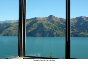 a view of a mountain view from a window at Akaroa Coastal Studio in Akaroa