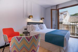 Postel nebo postele na pokoji v ubytování Hotel Boutique Puerta de las Granadas