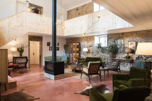 a living room filled with furniture and a fireplace at Quinta do Rio Noémi in Guarda