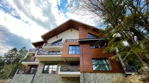 a tall building with windows on the side of it at Ama Apartament - Cota 1000 Sinaia in Sinaia