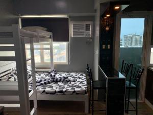 a bedroom with a bunk bed and a window at Anuva Condominium with Netflix in Manila