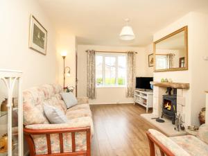 a living room with a couch and a fireplace at Yr Hafan in Colwyn Bay