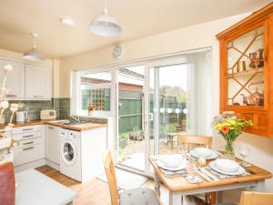 a kitchen and dining room with a table and a dining room at Yr Hafan in Colwyn Bay