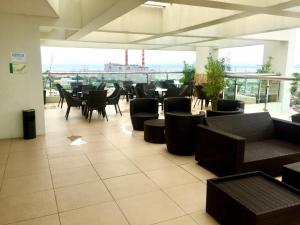 a restaurant with tables and chairs and a large window at Anuva Condominium with Netflix in Manila