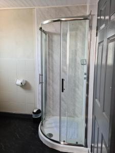 a shower with a glass door in a bathroom at Royal Albion Walton in Walton-on-the-Naze