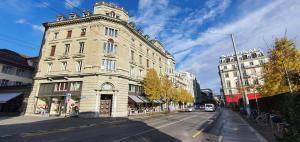 a tall white building on a city street at Belle Epoque Luzern in Lucerne