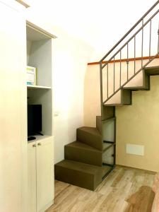 a staircase with a television in a room at Apartment Mary in Terracina