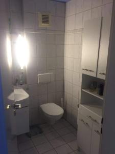 a white bathroom with a toilet and a sink at Tübingen Denzenberg / MIT GARTEN / FREE Parking in Tübingen