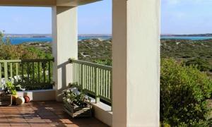 a porch of a house with a view of the ocean at Langebaan Paradise Beach 9 Elara in Langebaan