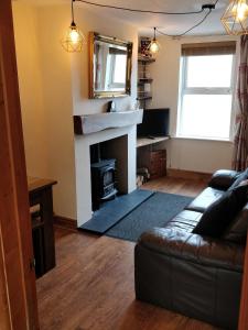 a living room with a fireplace and a couch at Town Centre House with parking in Cheltenham