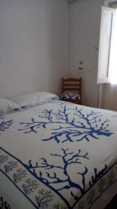 מיטה או מיטות בחדר ב-Casa Minerva Favignana -Cala rotonda
