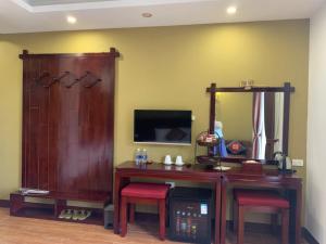 a room with a desk with two chairs and a mirror at Sapa Melody Hotel in Sa Pa