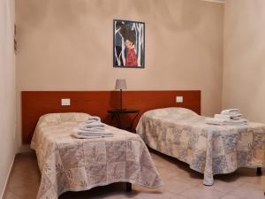 Posteľ alebo postele v izbe v ubytovaní Casa Colonna Montegrotto terme