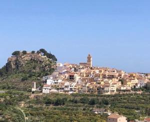 a town on top of a hill with houses at Casa El Castellet en Polop. in Polop