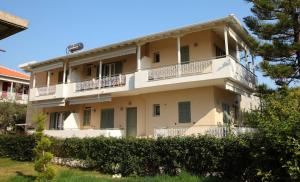 a large white building with balconies on top of it at Alisahni studios in Nikiana