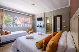 a bedroom with two beds and a large window at Paternoster Hotel in Paternoster +25 photos