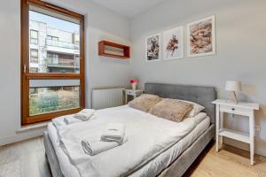 Posteľ alebo postele v izbe v ubytovaní Dom & House - Apartamenty Nadmorski Dwór