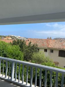 a balcony with a view of a house at Petit Porto Cervo in Porto Cervo