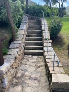 
a set of stairs leading up to a stone wall at Petit Porto Cervo in Porto Cervo
