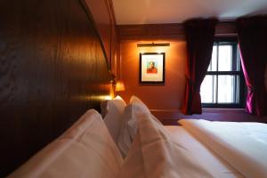 a bedroom with three beds and a window at Mimi's Hotel Soho in London
