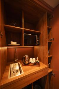 a kitchen with a sink and a microwave at Mimi's Hotel Soho in London