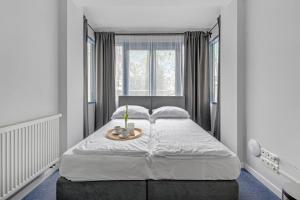 a bedroom with a large bed with a tray on it at Przystanek Sopot Plaża in Sopot