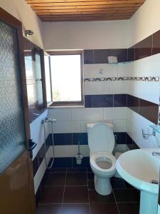 a bathroom with a toilet and a sink at Villa Mondi in Ksamil