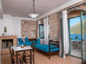 a living room with a blue couch and a table at Selana Studios in Neo Itilo