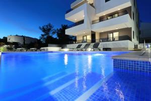 a villa with a swimming pool at night at Villa Ankora 1 with heated pool in Biograd na Moru