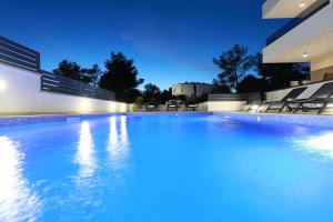 a swimming pool in a house with blue lighting at Villa Ankora 1 with heated pool in Biograd na Moru