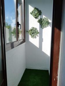 a hallway with green flooring and a door with windows at Alda Centro Pamplona in Pamplona