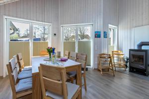 a dining room and living room with a table and chairs at Haus Deik in Büsum