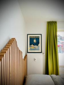 a bedroom with a bed and a green curtain at BÄRENALP Ferienwohnen in Garmisch-Partenkirchen