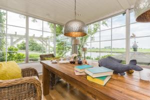 un comedor con una mesa con libros. en Fährhauslodges Natur in Sicht, en Norden