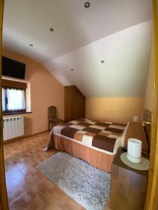 a bedroom with a large bed and a rug at Casa Xuanón in Muñalén